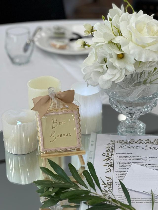 Candlelit dinner table with white roses and a hand-tied place card at an Urban Pop Ups charity fundraiser in Perth