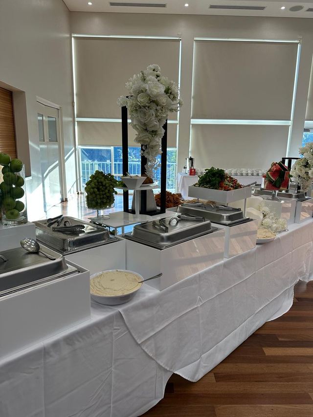 Halaal buffet dressed in white linen and roses at the Pop Up for Palestine fundraiser dinner
